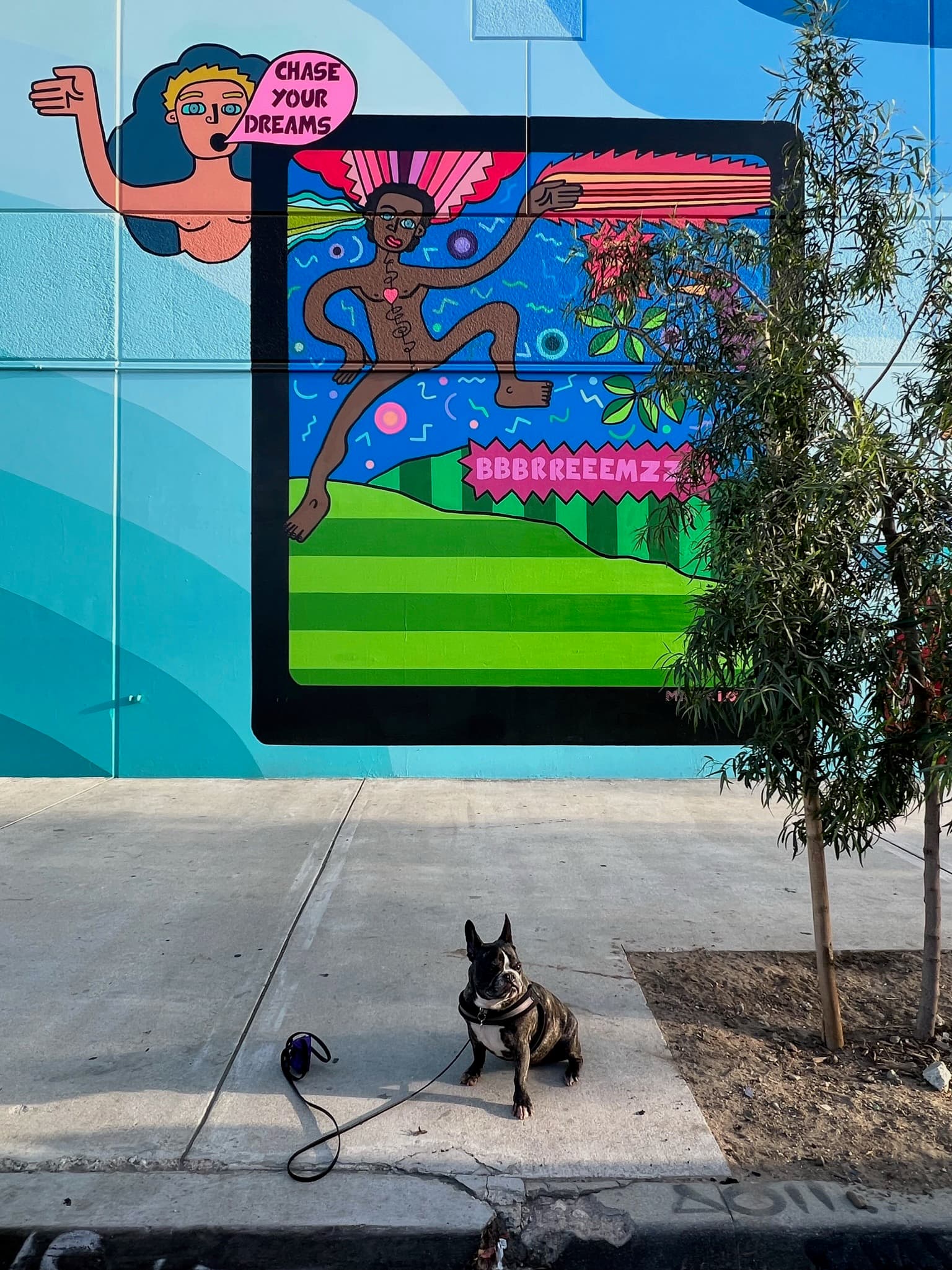 Maddie standing in front of street art in Arts District, Los Angeles
