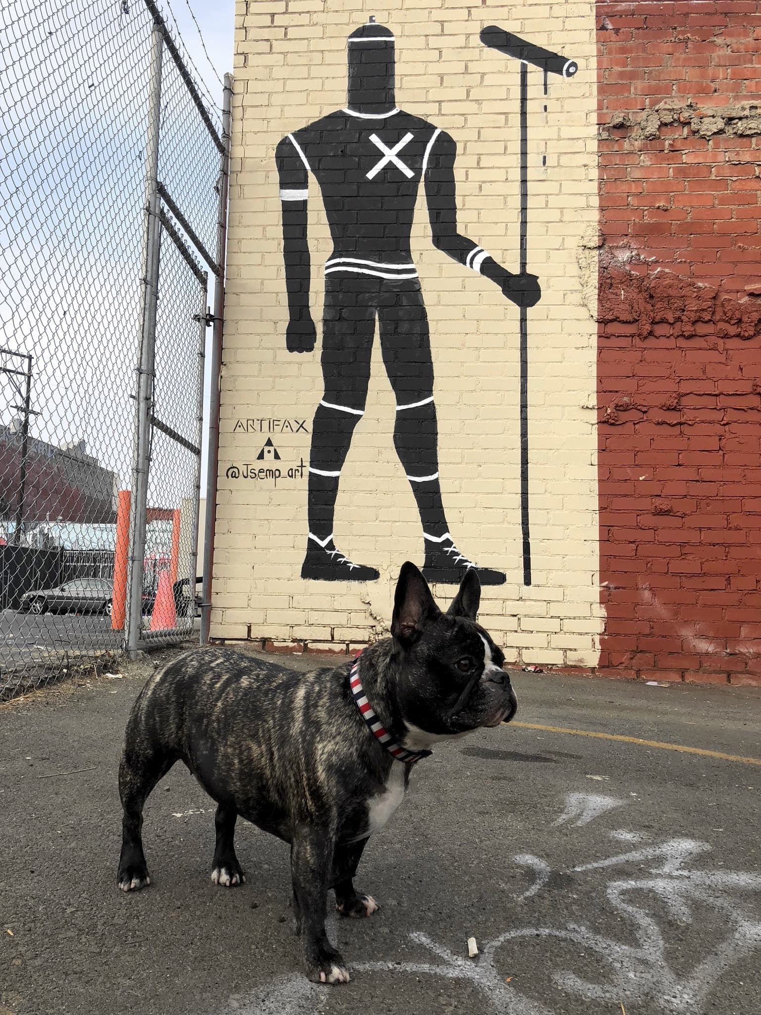 Maddie standing in front of street art in Needs location, Location unknown